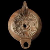 A Roman Pottery Oil Lamp with an Oak Garland