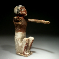 An Egyptian Middle Kingdom Wood Statuette