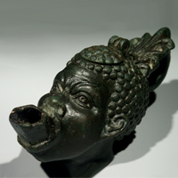 A Roman Bronze Oil Lamp in the Shape of the Head of an African